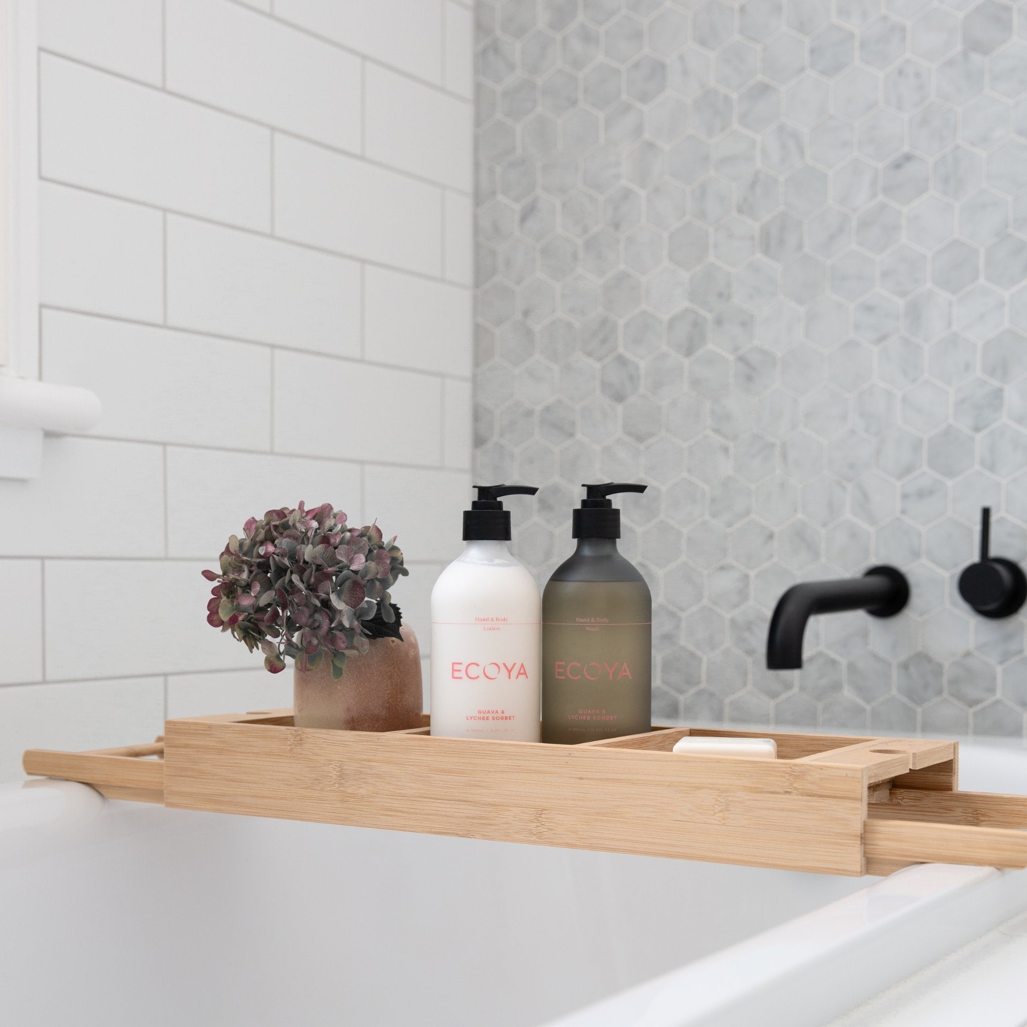 Two hand pumps sitting on bath tray