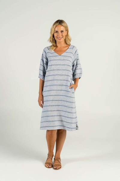 A confident model showcases effortless summer style in the V-Neck Linen Dress with classic blue and white stripes. The flattering V-neck design and breathable linen fabric create a cool and comfortable look, perfect for any occasion.