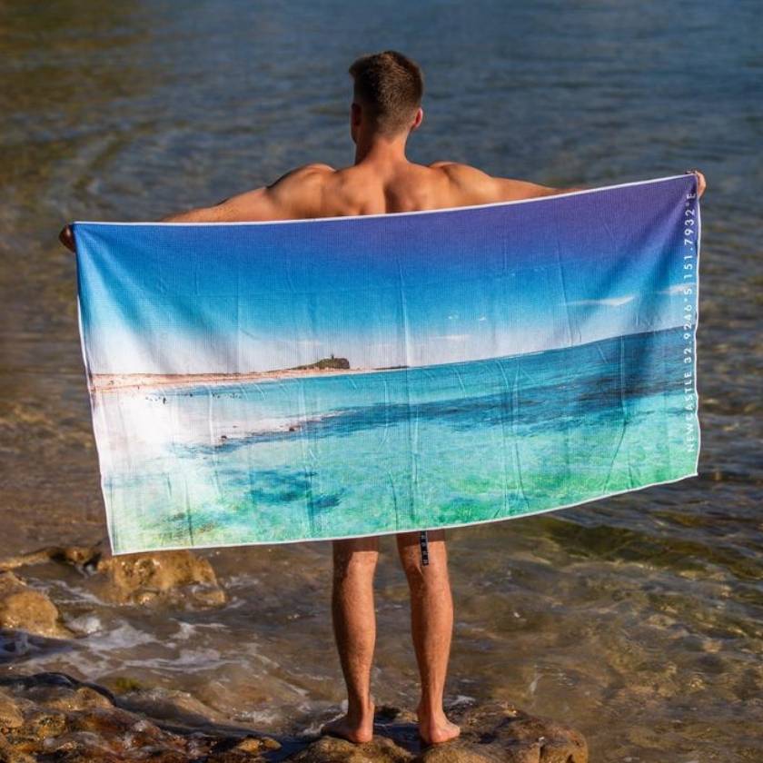 Man holding newy beach towel