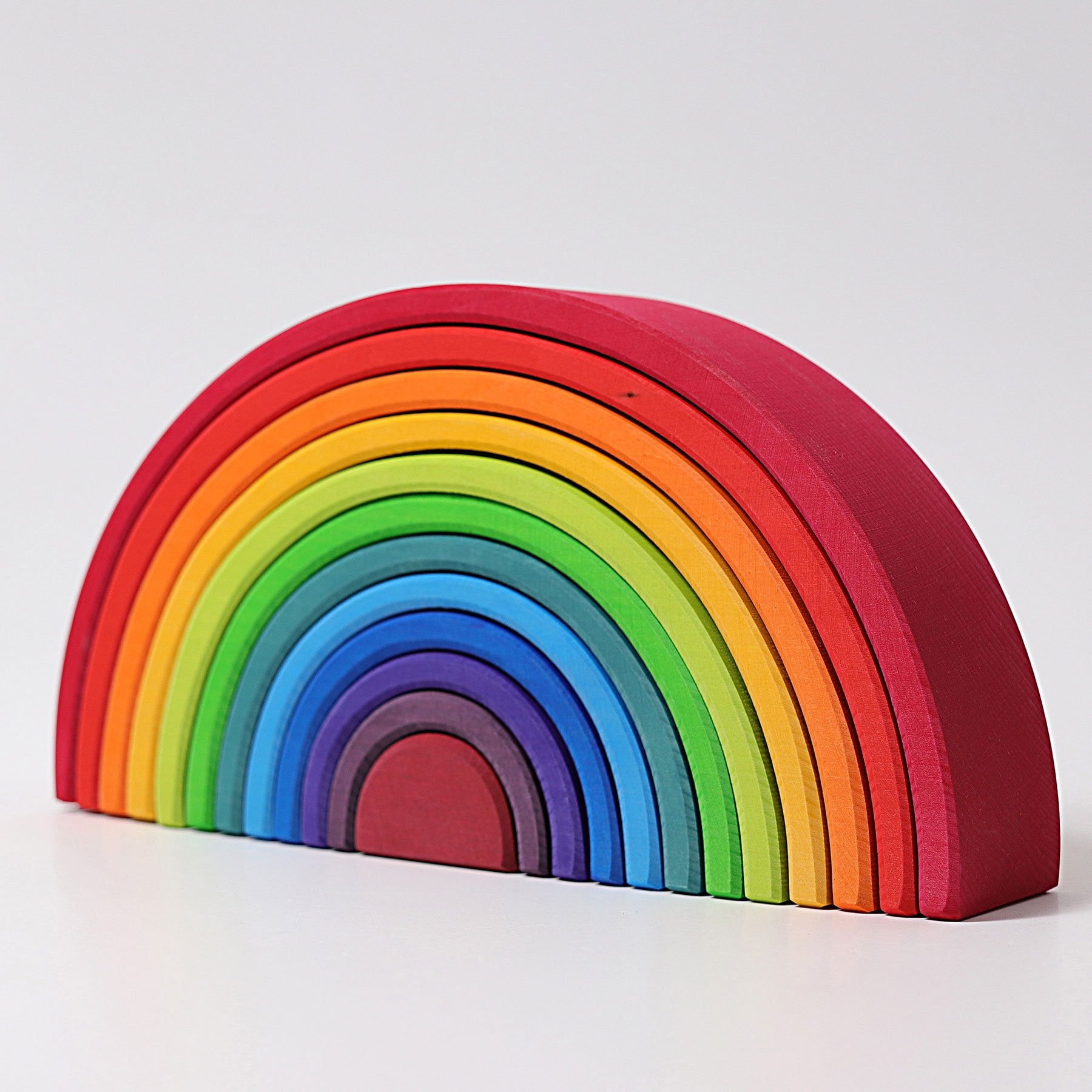 Bright rainbow wooden stacking toy by Grimm's. 