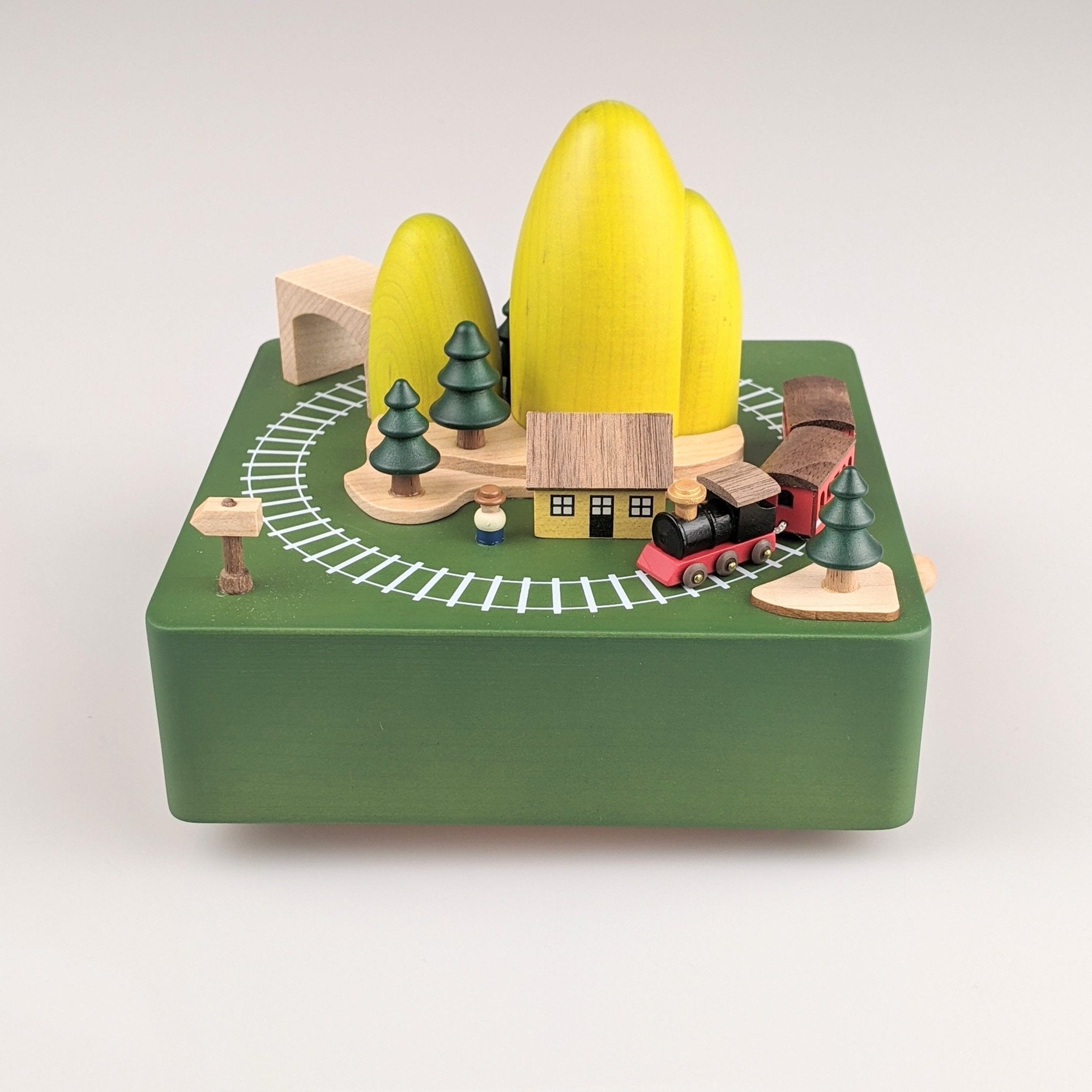 Wooden music box with train going around a mountain