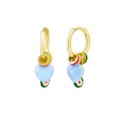 Gold hoop earrings with blue heart charms on a white background by Tiger Tree