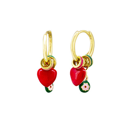 Gold hoop earrings with red heart charms on a white background by Tiger Tree