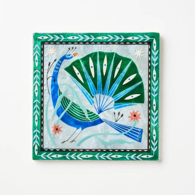 Decorative tile with a peacock design on a white background