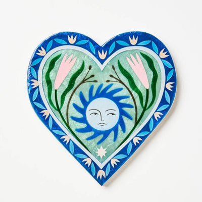 Heart-shaped decorative artwork with a sun and floral design on a white background