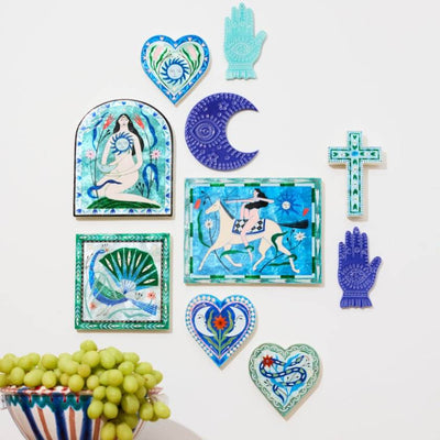 Collection of decorative tiles with artistic designs on a white background