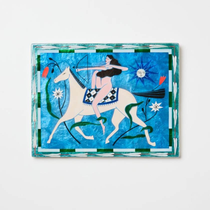 Decorative artwork with a stylized design of a woman on a horse against a blue background.