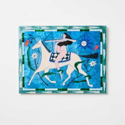Decorative artwork with a stylized design of a woman on a horse against a blue background.