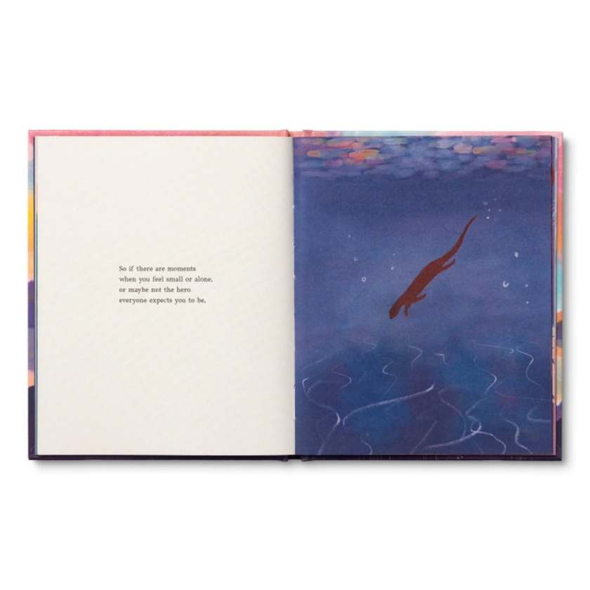 Open book with a colorful illustration of a fish in water on one page and text on the other, against a white background.