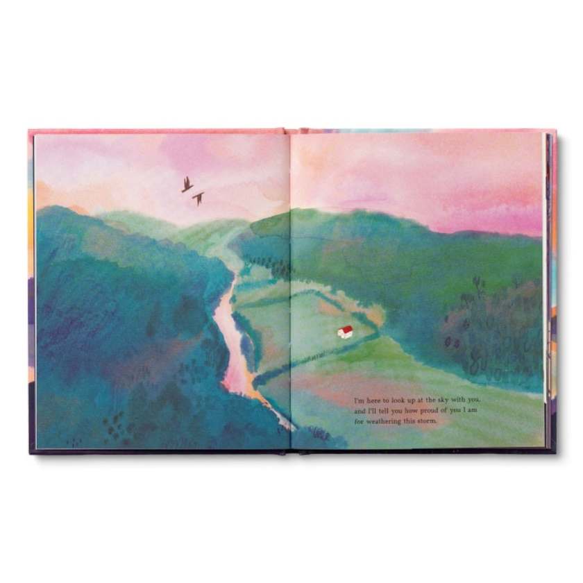 Open book with a colorful landscape illustration on a white background