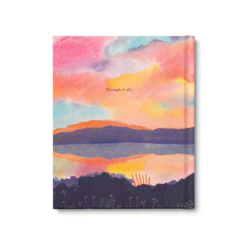 Notebook with a colorful sunset design on the cover