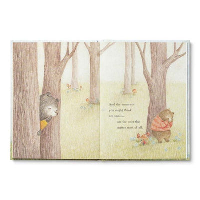 Illustrated book open to a page with animals in a forest setting