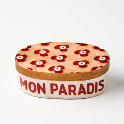 Ceramic container with floral lid and 'MON PARADIS' text on a white background