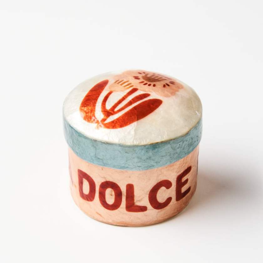 Small round container with 'DOLCE' text on a white background
