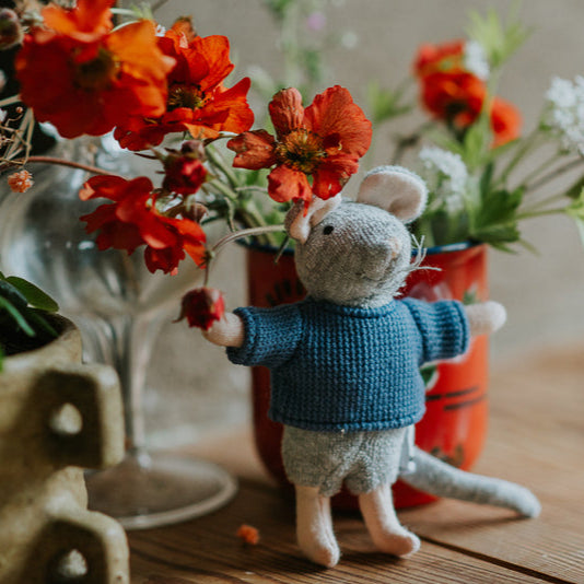 Small mouse figurine holding a red flower in front of floral arrangements on a wooden surface | Stockist at Zebra Finch Style, Newcastle, NSW