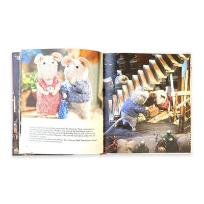 Open book showing illustrations of toy mice in a workshop setting