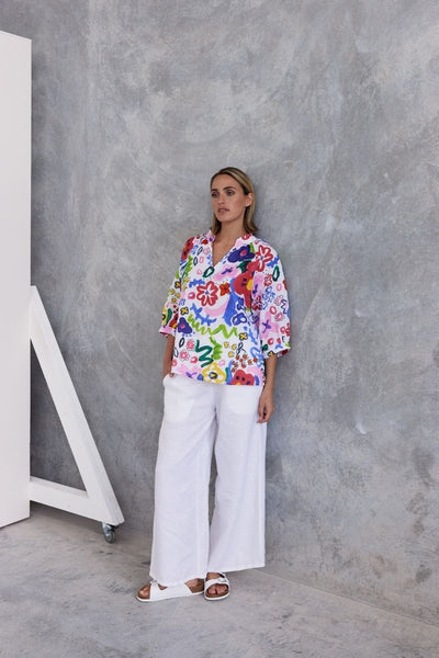 A half sleeve 100% linen top with a bright floral design by Wear Colour (sister brand to See Saw), designed in Australia