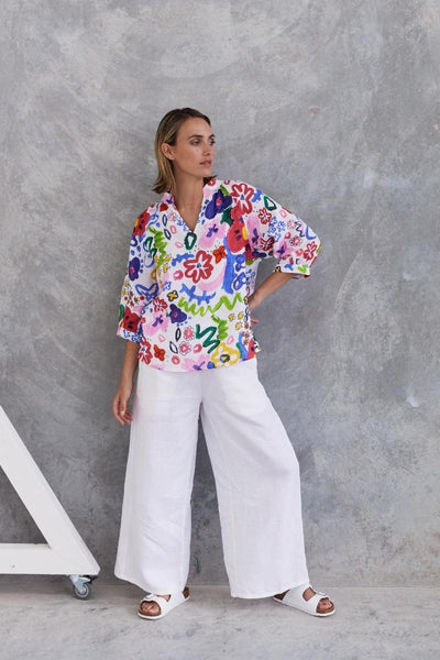 A half sleeve 100% linen top with a bright floral design by Wear Colour (sister brand to See Saw), designed in Australia