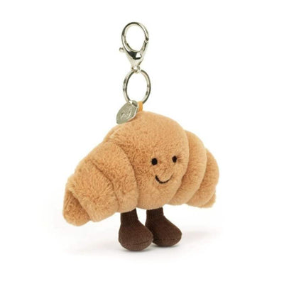 Plush croissant keychain with a smiling face on a white background by Jellycat | Jellycat Stockist at Zebra Finch Marketown in Newcastle, NSW