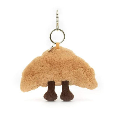 Plush croissant keychain with a smiling face on a white background by Jellycat | Jellycat Stockist at Zebra Finch Marketown in Newcastle, NSW