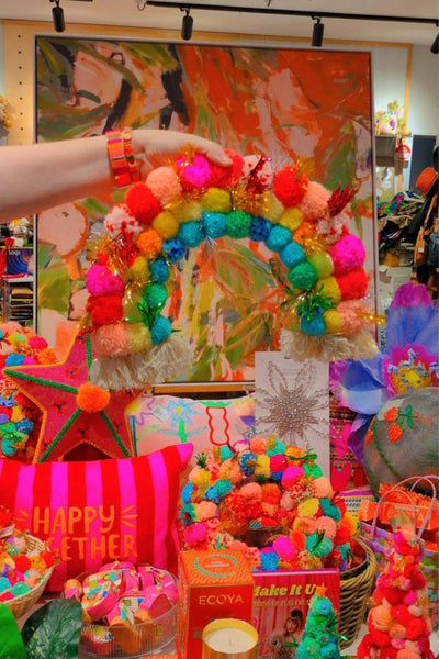 Colorful pom-pom rainbow with a star decoration against an abstract background | Pom pom rainbow by Arissa Lifestyle available at Zebra Finch Style in Newcastle, NSW