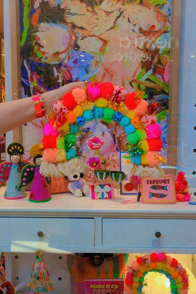 Colorful pom-pom rainbow with a star decoration against an abstract background | Pom pom rainbow by Arissa Lifestyle available at Zebra Finch Style in Newcastle, NSW
