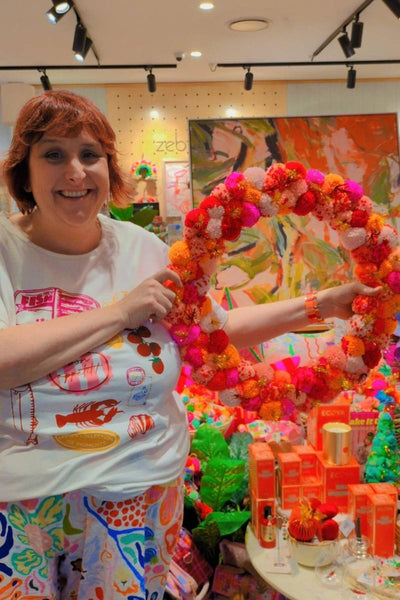 Colourful pink and orange pom pom wreath by Arissa Lifestyle available at Zebra Finch Style in Newcastle, NSW