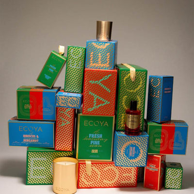 Collection of ECCOYA candles and boxes on a gray background