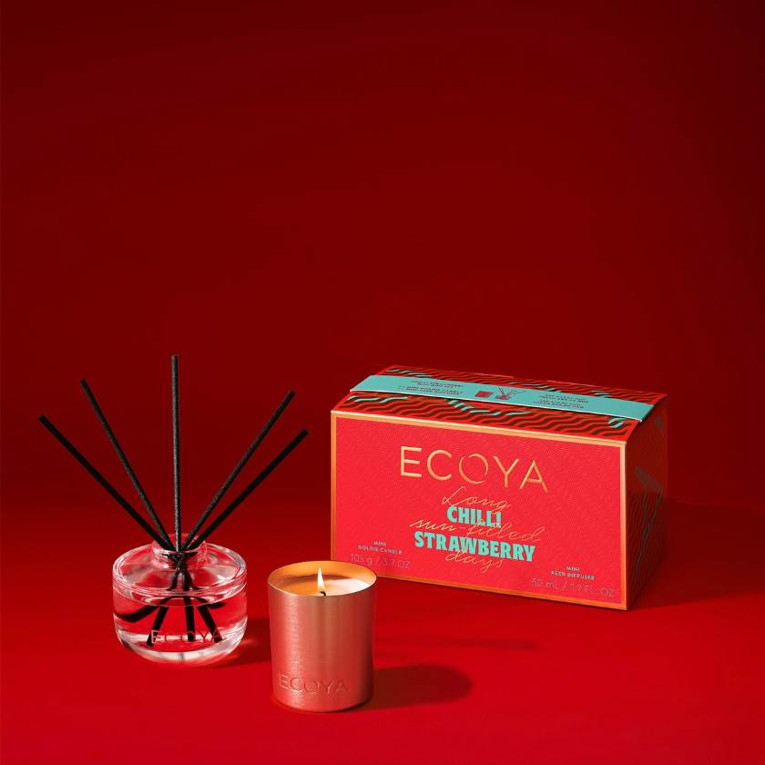 Ecoya Chilli Strawberry diffuser, candle, and packaging on a red background