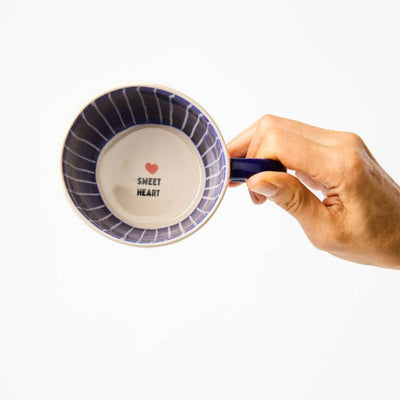 Hand holding a mug with 'Sweet Heart' text and heart design on a white background