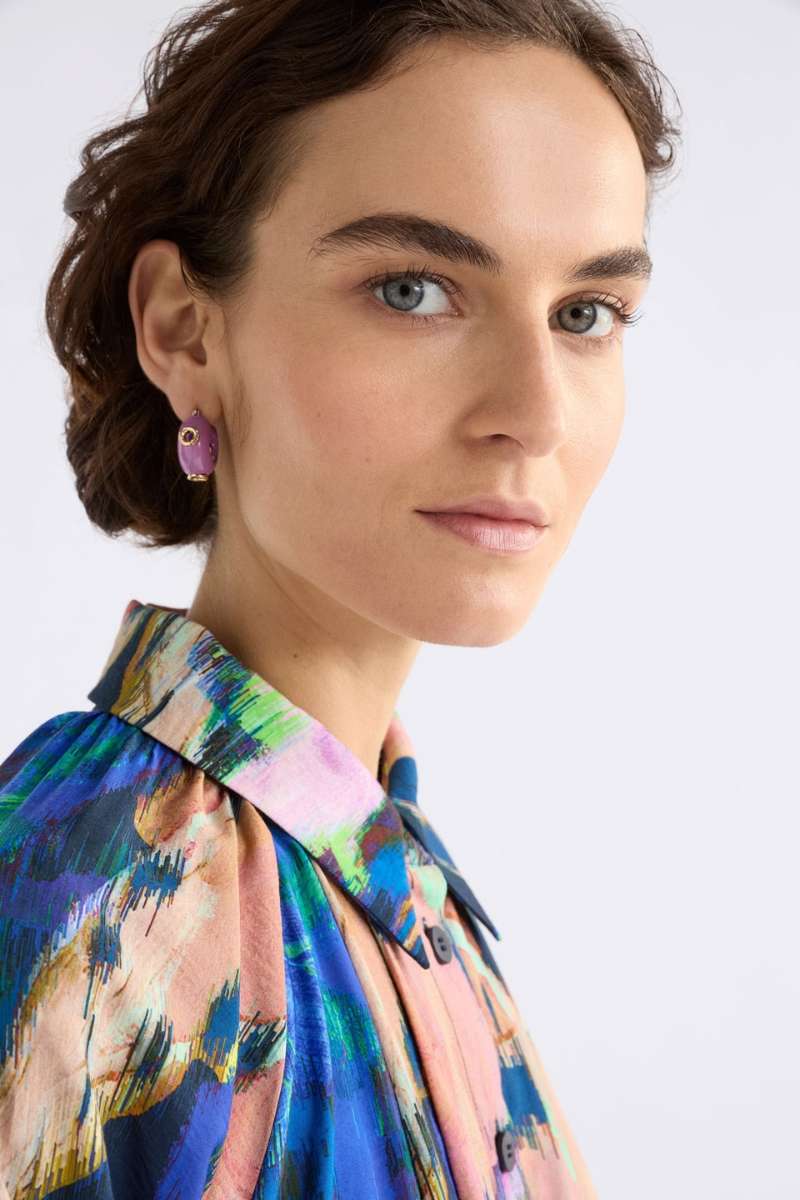 Woman wearing a colourful patterned blouse with ELK's Lilac Jans studs. ELK Stockist in Newcastle, NSW at Zebra Finch