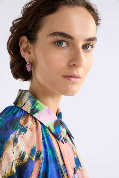 Woman wearing a colourful patterned blouse with ELK's Lilac Jans studs. ELK Stockist in Newcastle, NSW at Zebra Finch