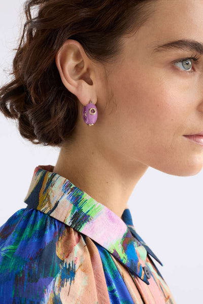 Woman wearing a colourful patterned blouse with ELK's Lilac Jans studs. ELK Stockist in Newcastle, NSW at Zebra Finch