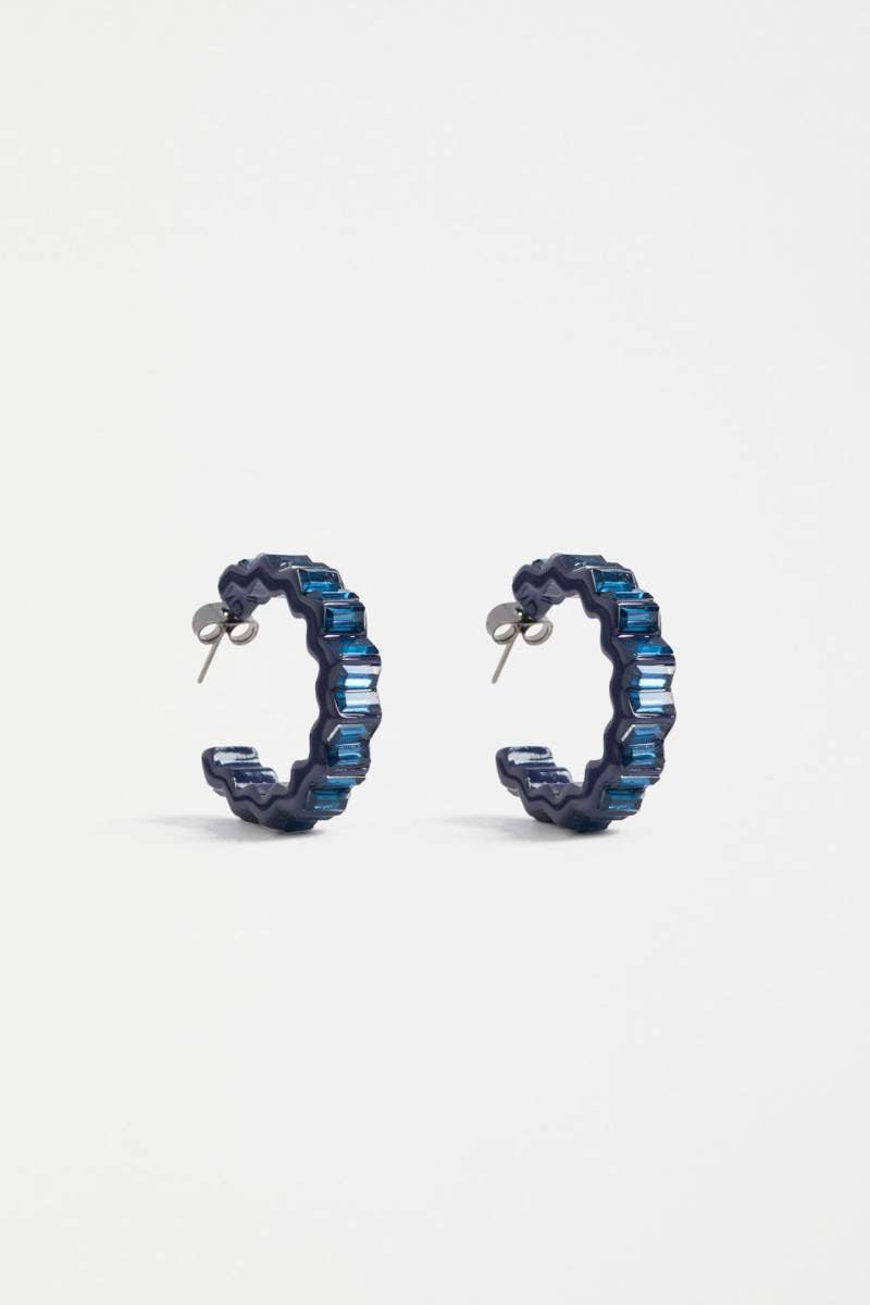 Pair of blue hoop earrings on a light gray background