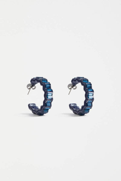 Pair of blue hoop earrings on a light gray background