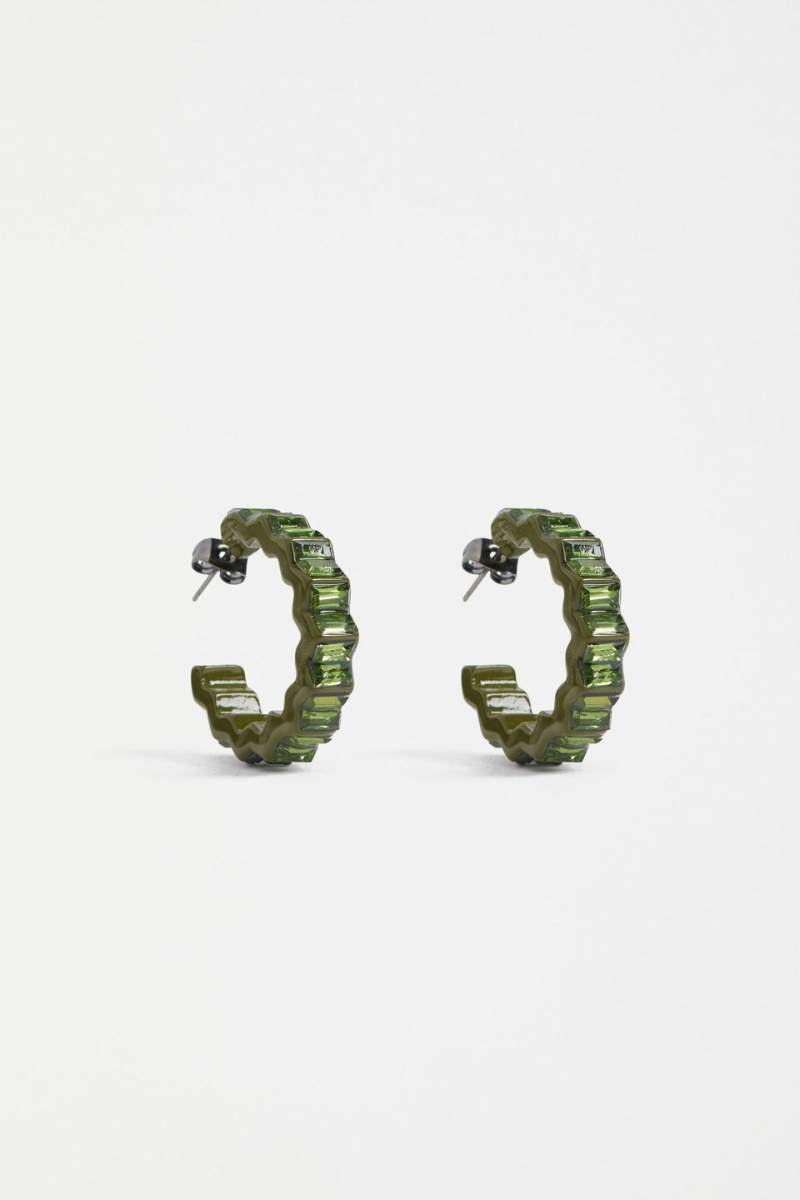 Green hoop earrings on a white background