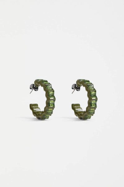 Green hoop earrings on a white background