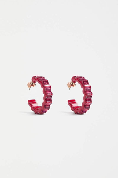 Pair of red hoop earrings on a light gray background