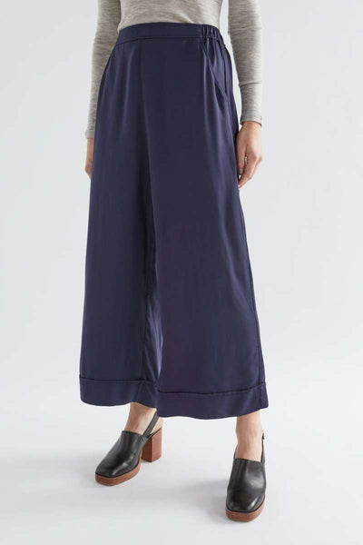 Navy wide-leg pants worn by a person on a white background  Elk's Moonlight wide leg culottes