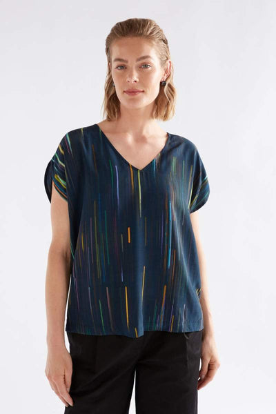 Woman wearing a blue patterned top on a white background