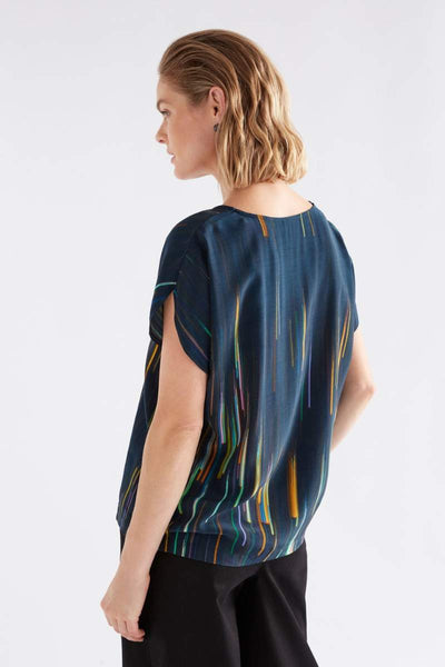 Woman wearing a blue patterned top on a white background