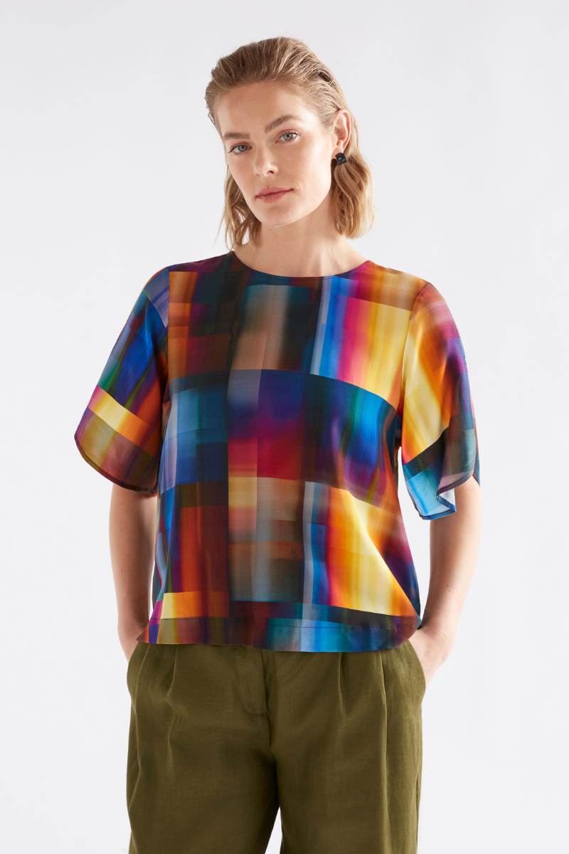 Person wearing a colorful checkered blouse with green pants on a white background by Elk the Label | Elk Stockist in Newcastle at Zebra FInch Style