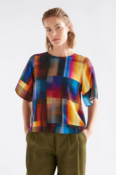 Person wearing a colorful checkered blouse with green pants on a white background by Elk the Label | Elk Stockist in Newcastle at Zebra FInch Style