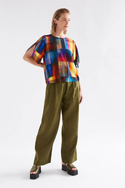 Person wearing a colorful plaid shirt and green pants on a white background by Elk the Label | Elk Stockist in Newcastle at Zebra FInch Style