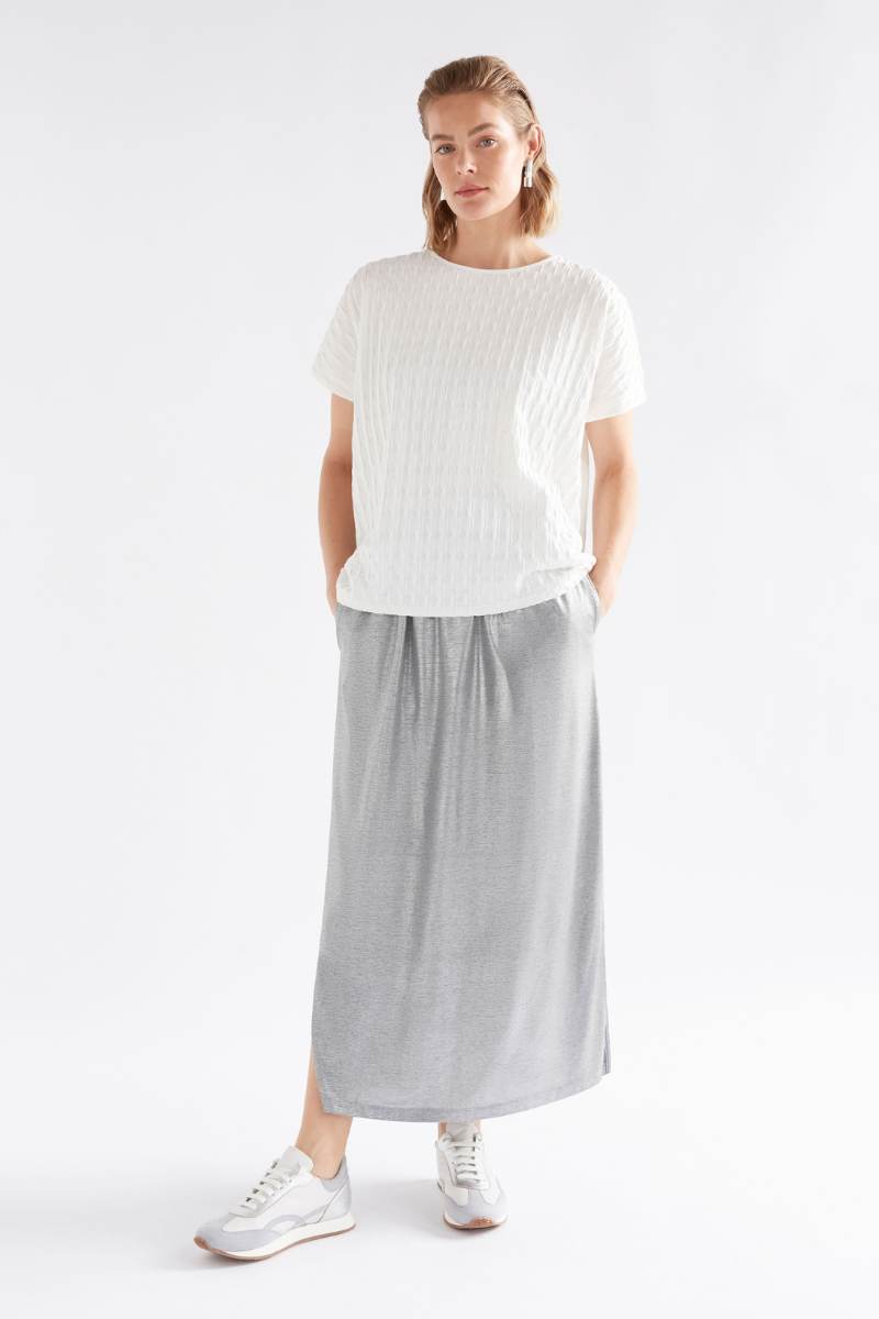 Person wearing a white t-shirt and gray skirt on a white background Woman wearing a white textured top and gray pants on a light background by Elk the Label | Elk Stockist in Newcastle, NSW at Zebra Finch Style