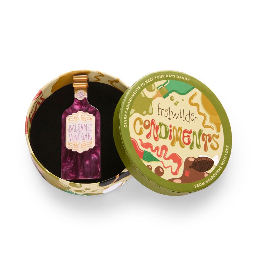 Bottle of balsamic vinegar with a marbled design on a white background - resin brooch by Erstwilder from their 2025 Condiments collection