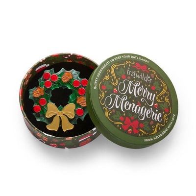 Christmas wreath ornament with red berries, gold bow, and acorns on a white background | Erstwilder brooch from their 2025 Christmas collection