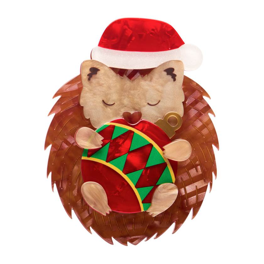 Hedgehog wearing a red Santa hat holding a Christmas ornament on a white background | Resin brooch by Erstwilder from their 2025 Christmas collection