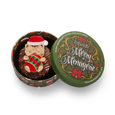 Hedgehog wearing a red Santa hat holding a Christmas ornament on a white background | Resin brooch by Erstwilder from their 2025 Christmas collection