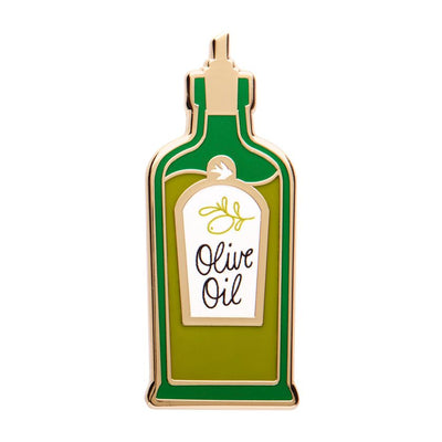 Enamel pin shaped like an olive oil bottle with a label on a white background - from Erstwilder's 2025 Condiments collection